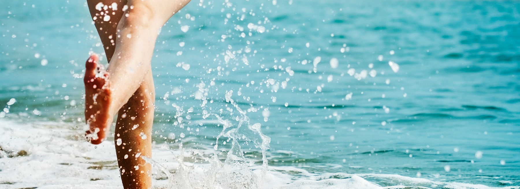 A person splashing in the water at the beach
